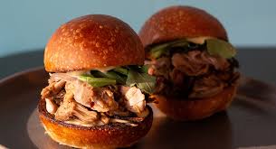 Comfort Kitchen signature dishes Jerk Jackfruit Sliders, Yassa Chicken, and Gullah-inspired rice dishes.